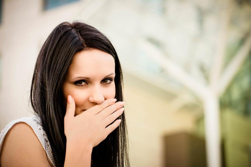 woman covering mouth from bad breath