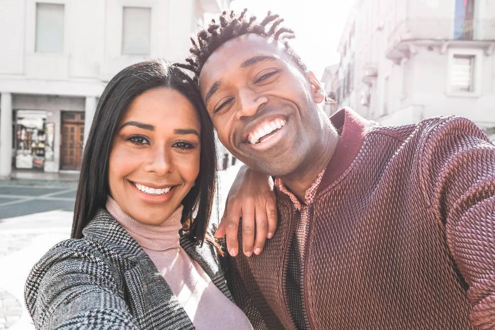 man and woman smiling with bright teeth