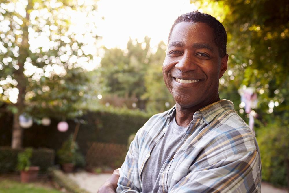 man smiling after getting dental implants in woodland hills