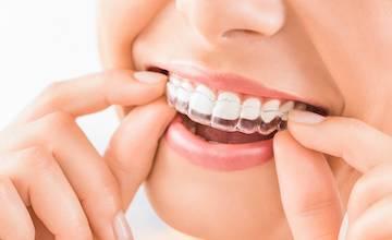 close up of woman using invisalign