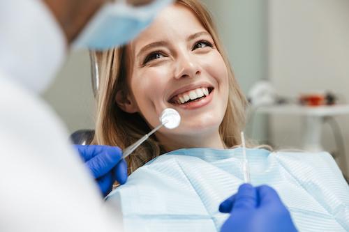 woman smiling after getting a dental crown
