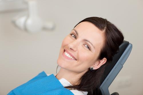 woman smiling in dental chair during preventive exam in woodland hills