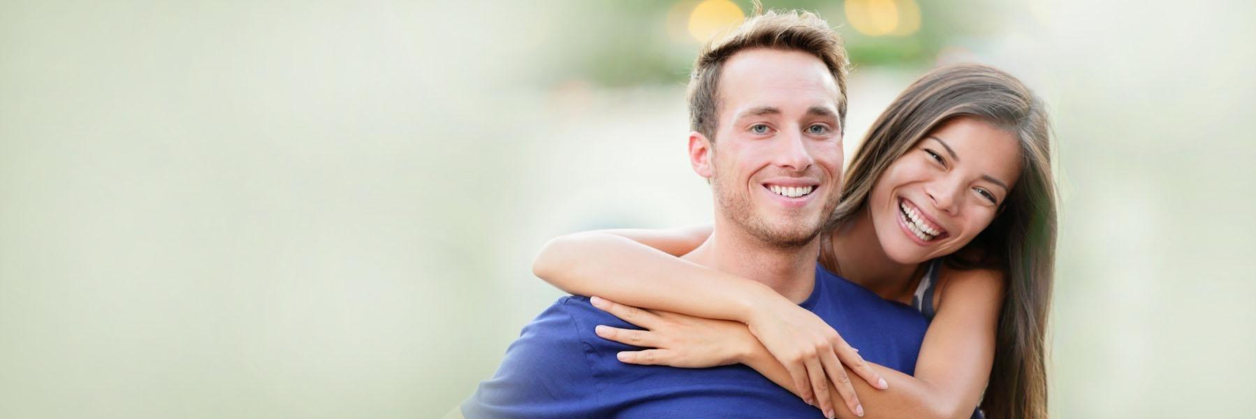 woodland hills woman hugging man's shoulders while both are smiling