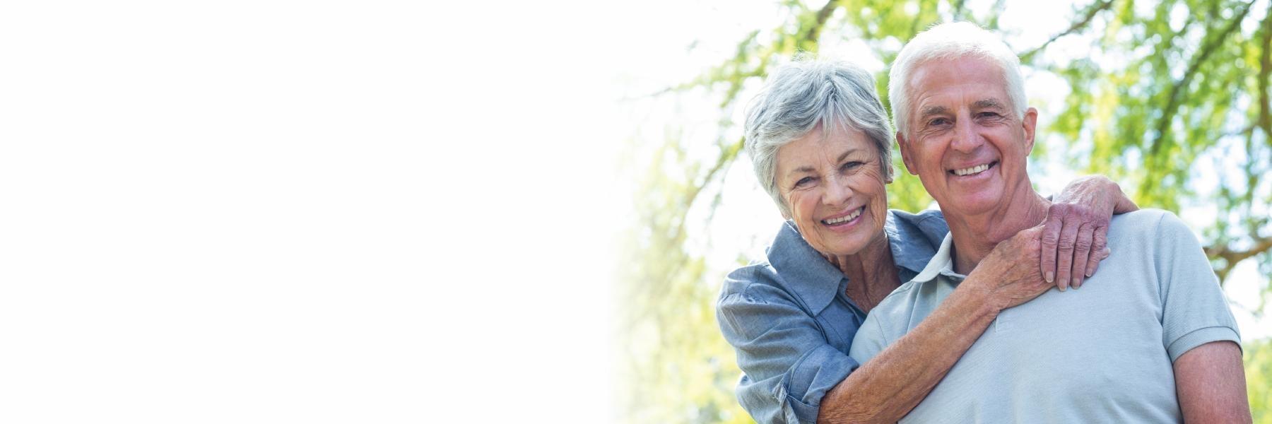 Older man and woman smiling in woodland hills
